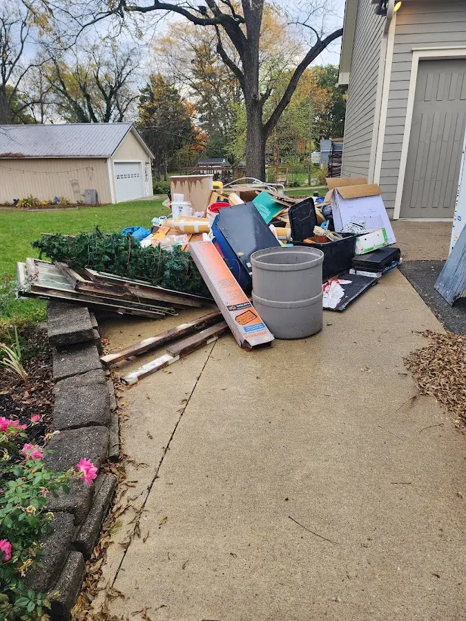 Dumpster being loaded with debris for Commercial Dumpster Rental in Wayzata